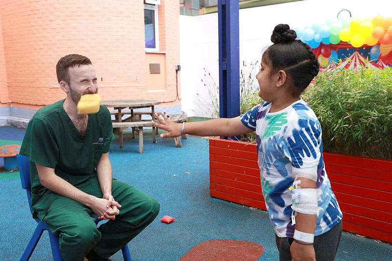 Dr Joseph Davies getting soaked by patient Dheeraj Singh