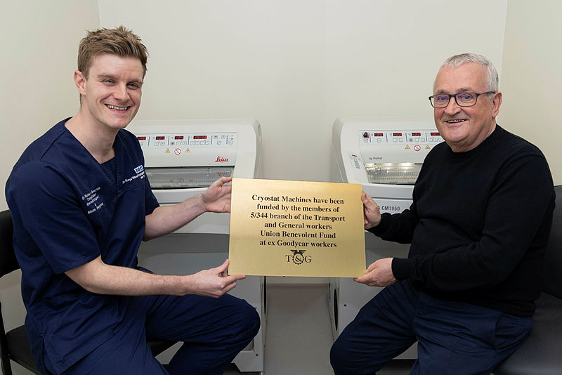 Latest News: Dr Jerrom with Cyril Barrett with the plaque in front of the cryostat machine