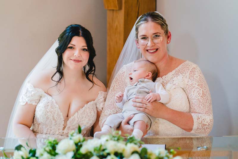 Hayley and Teri on their wedding day, holding Ralph