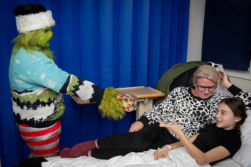 Latest News: The Grinch with mum Jill Moffatt and daughter Beau Melligan receiving her present on the bed