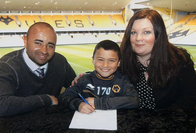 Latest News: Nathan aged seven signing for Wolves academy at Molineux flanked by Marc Campbell, then Head of Academy Coaching and Development at Wolves, and mum Tracy