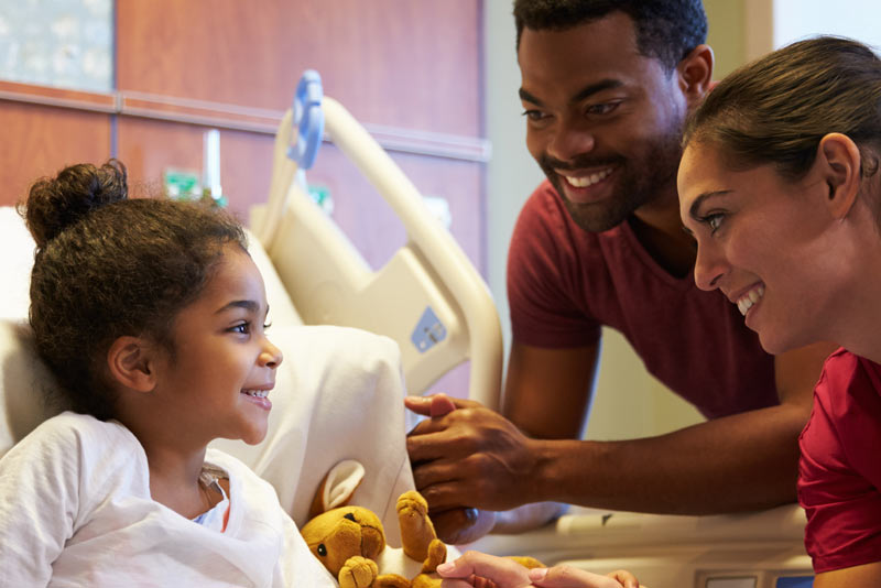 Parents visiting little girl in hospital